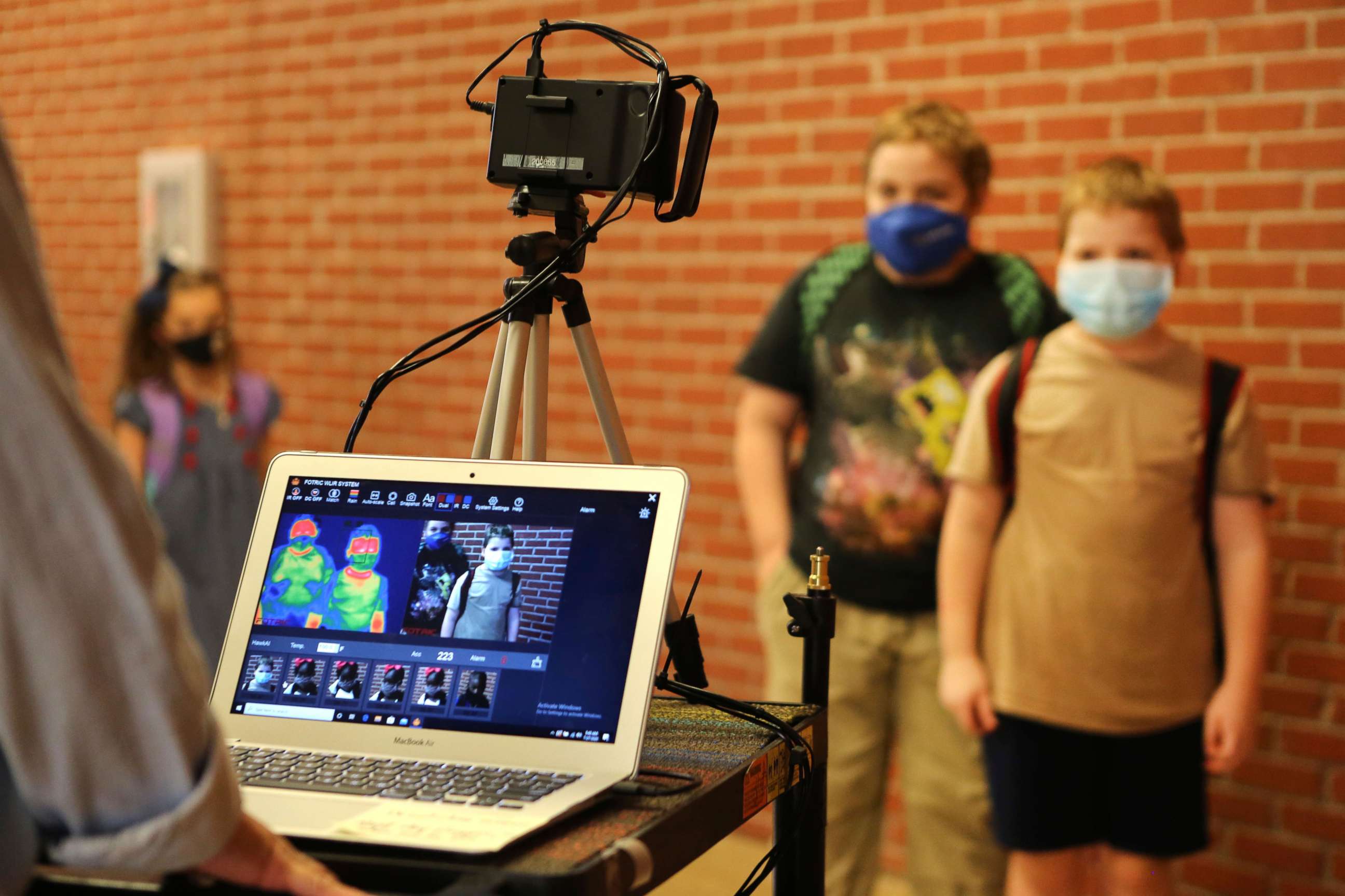 PHOTO: Corinth Elementary School students have their temperature checked by a thermal scanner as they arrive for their first day back to school Monday, July 27, 2020 in Corinth, Miss.