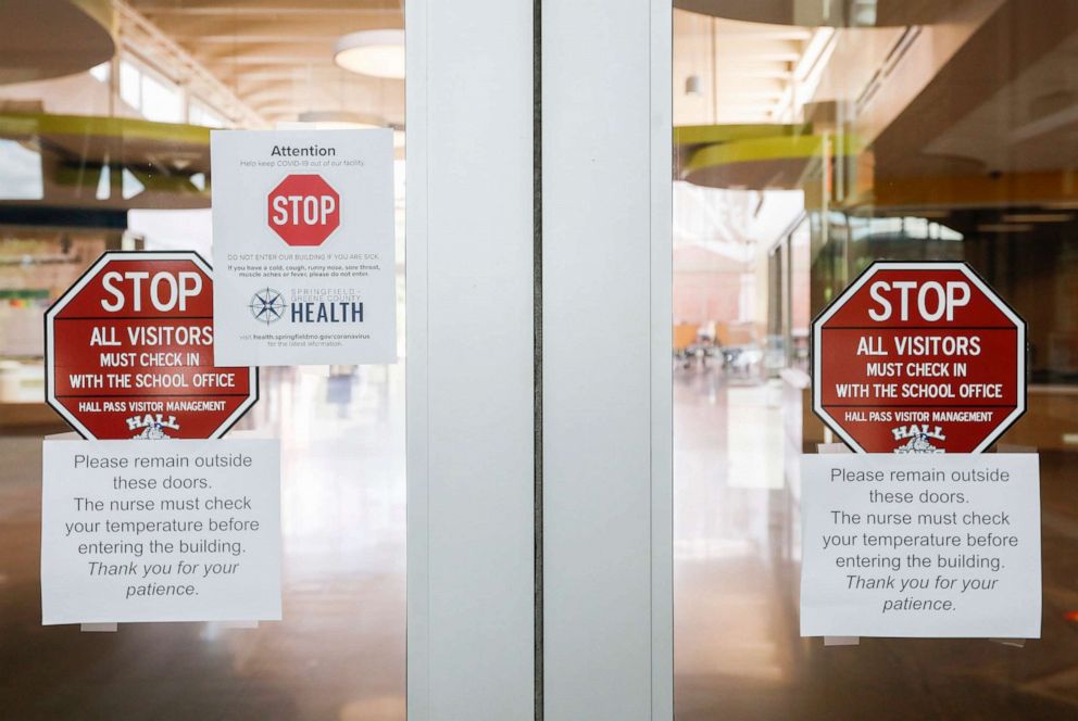 PHOTO: Signage advises people that they must have their temperature taken before entering Sherwood Elementary School in Springfield, Mo., to help prevent the spread of COVID-19, July 23, 2020.
