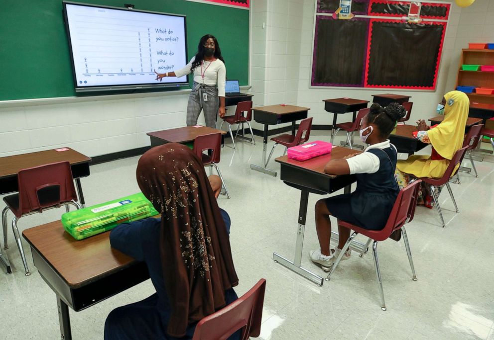 PHOTO: Kearra Holloway, a third grade teacher at McFerran Preparatory Academy, demonstrates what classroom spacing and teaching will look on Aug. 3, 2021, in Louisville, Ky.