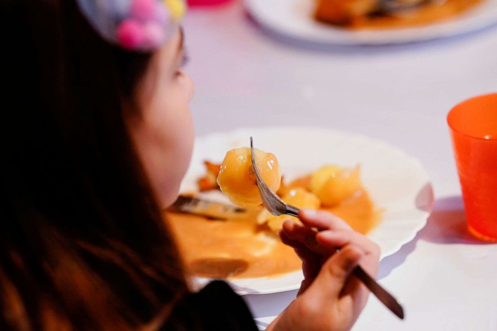 PHOTO: A child eats lunch at the Youth Church in the Waldhof district in Germany, Dec. 2, 2021. 