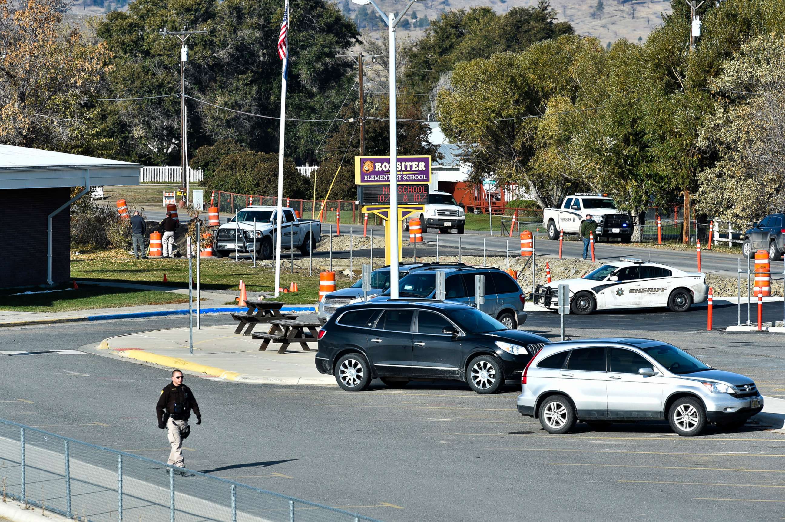 PHOTO: The Lewis and Clark County bomb squad works the scene at Rossiter Elementary school Oct. 15, 2019, after an improvised explosive device detonated on the school playground, in Helena, Mont.