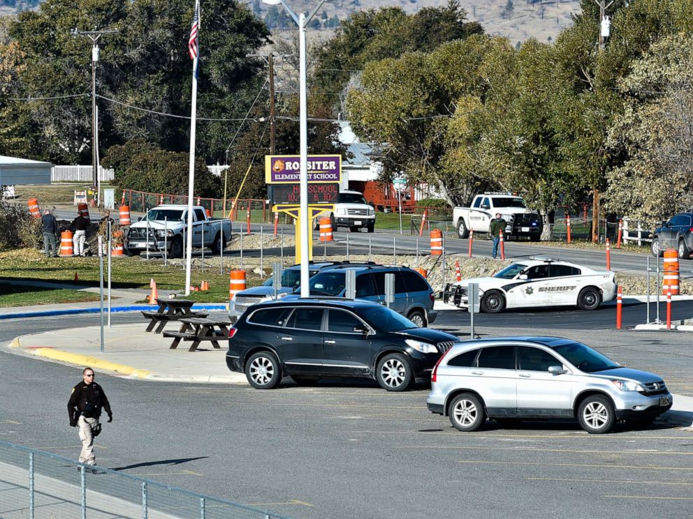PHOTO: The Lewis and Clark County bomb squad works the scene at Rossiter Elementary school Oct. 15, 2019, after an improvised explosive device detonated on the school playground, in Helena, Mont.