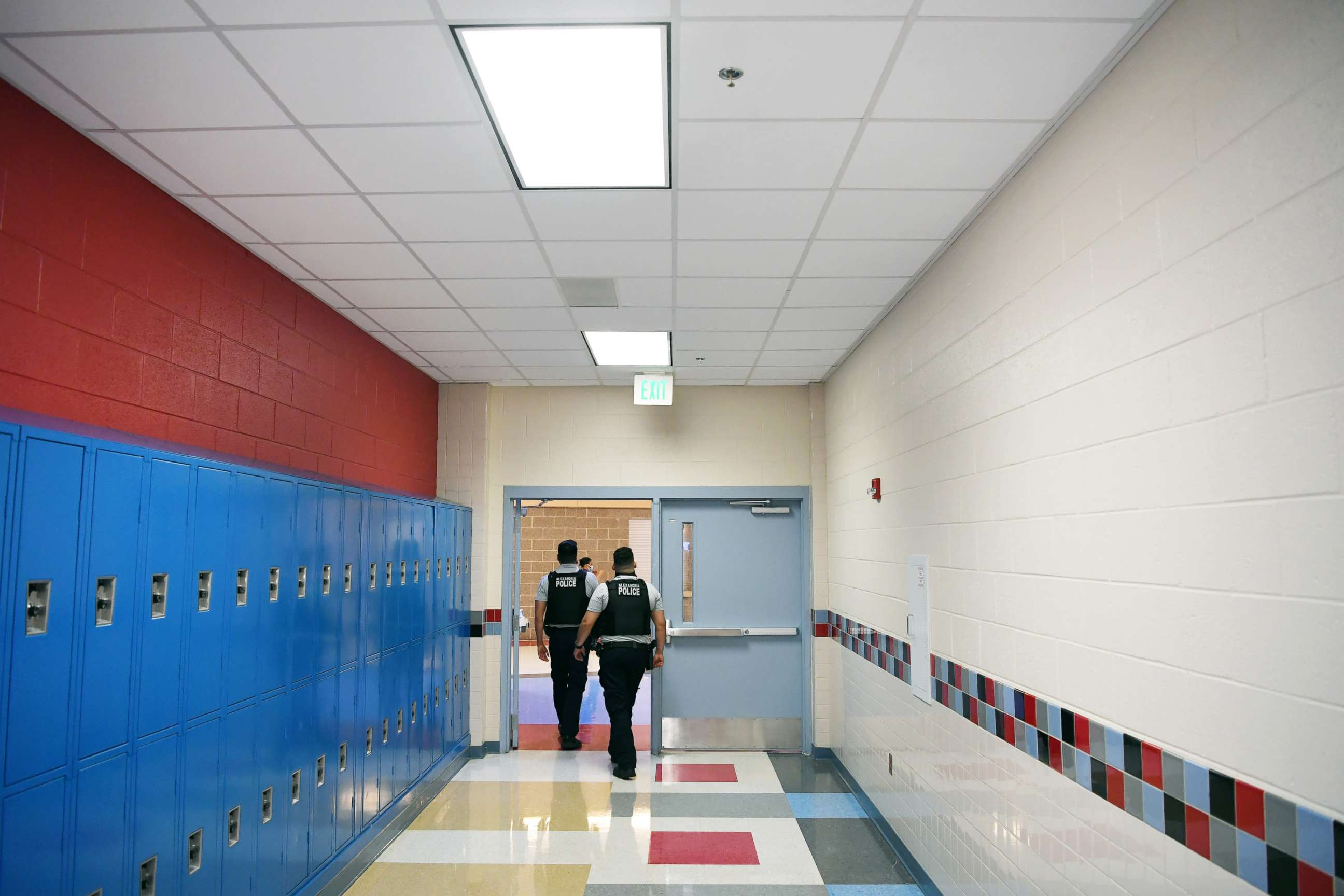 PHOTO: School resource officers walk through a hallway at T.C. Williams High School on June 09, 2021, in Alexandria, Va.
