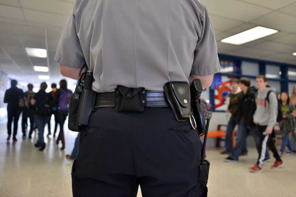 PHOTO: Officer Joe Plazio, of the Fairfax County Police Department, stays armed with his service pistol as he patrols the hallways where he is stationed at West Springfield High School, Jan. 18, 2012, in Springfield, Va.