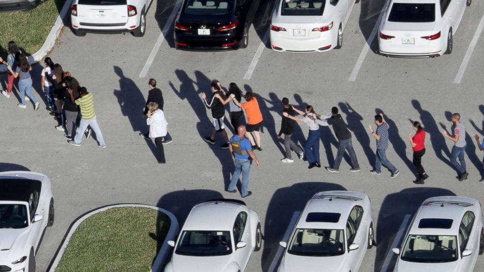 PHOTO: Students are evacuated by police from Marjory Stoneman Douglas High School in Parkland, Fla., after a mass shooting on Feb. 14, 2018.