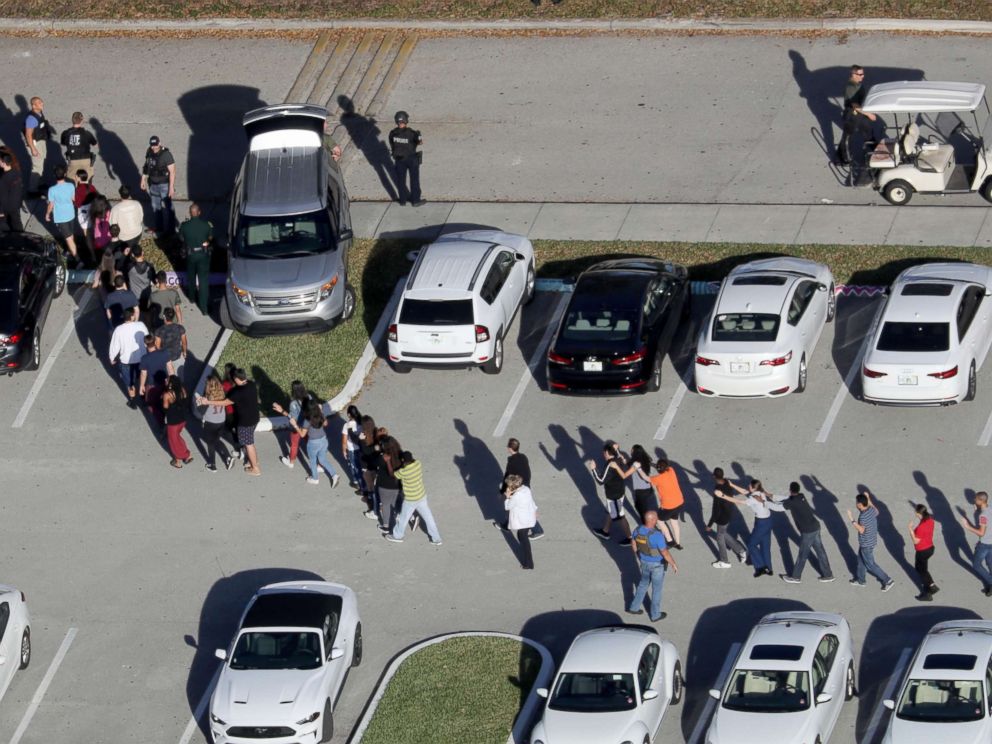 PHOTO: Students are evacuated by police from Marjory Stoneman Douglas High School in Parkland, Fla., after a mass shooting on Feb. 14, 2018.