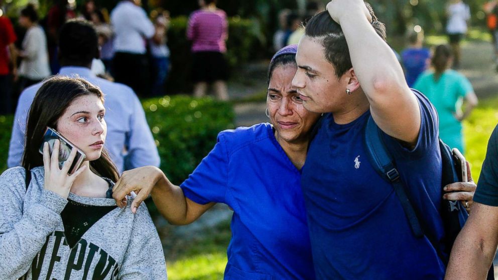 PHOTO: Students and parents embrace after a mass shooting at the Marjory Stoneman Douglas High School in Parkland, Fla., Feb. 14, 2018.