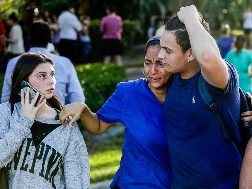 PHOTO: Students and parents embrace after a mass shooting at the Marjory Stoneman Douglas High School in Parkland, Fla., Feb. 14, 2018.