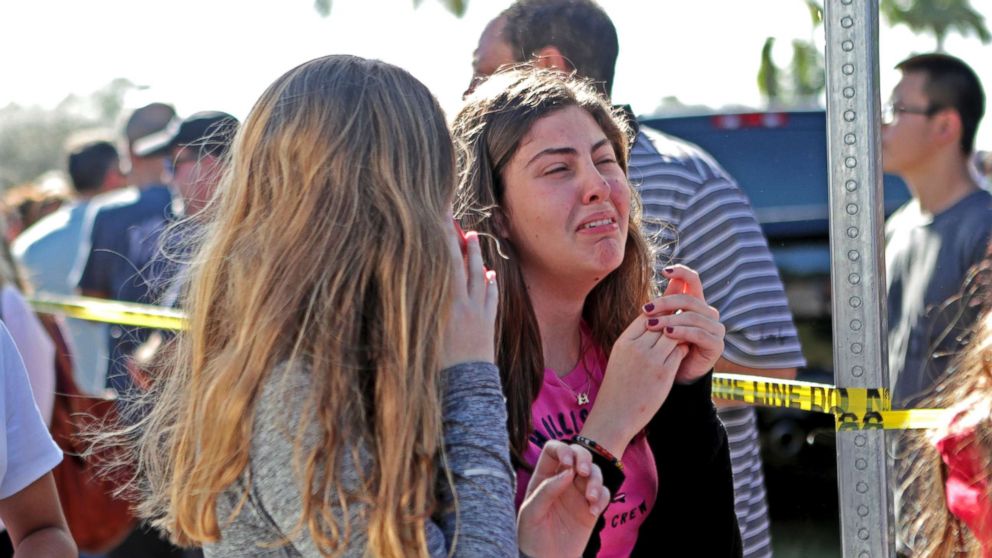 Students released from a lockdown are overcome with emotion following following a shooting at Marjory Stoneman Douglas High School in Parkland, Fla., Feb. 14, 2018.