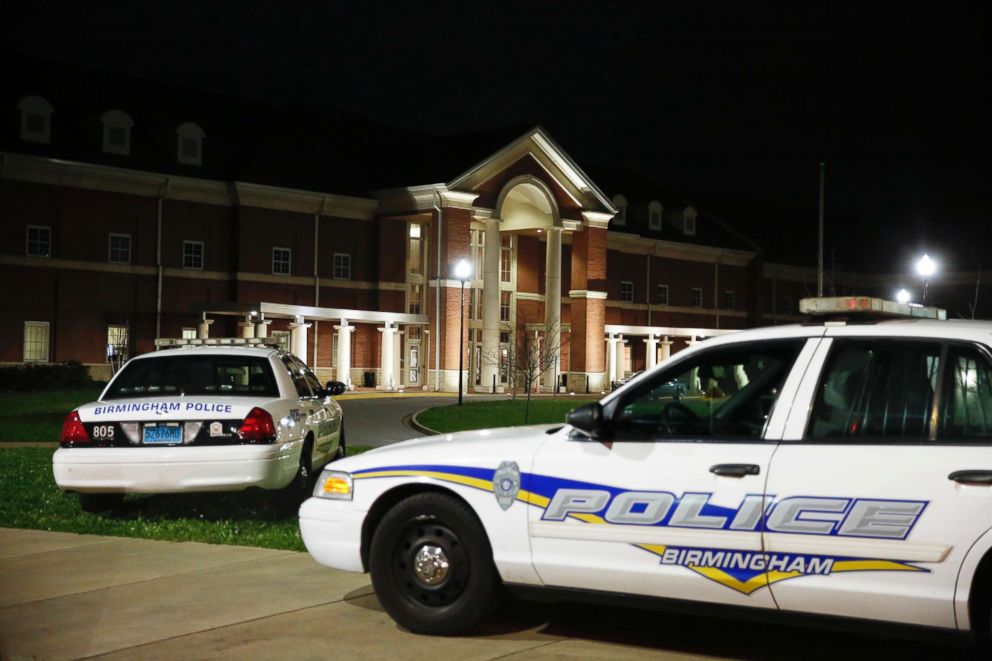 PHOTO: Huffman High School is seen behind Birmingham Police cars after at a shooting, March 7, 2018, in Birmingham, Ala. 