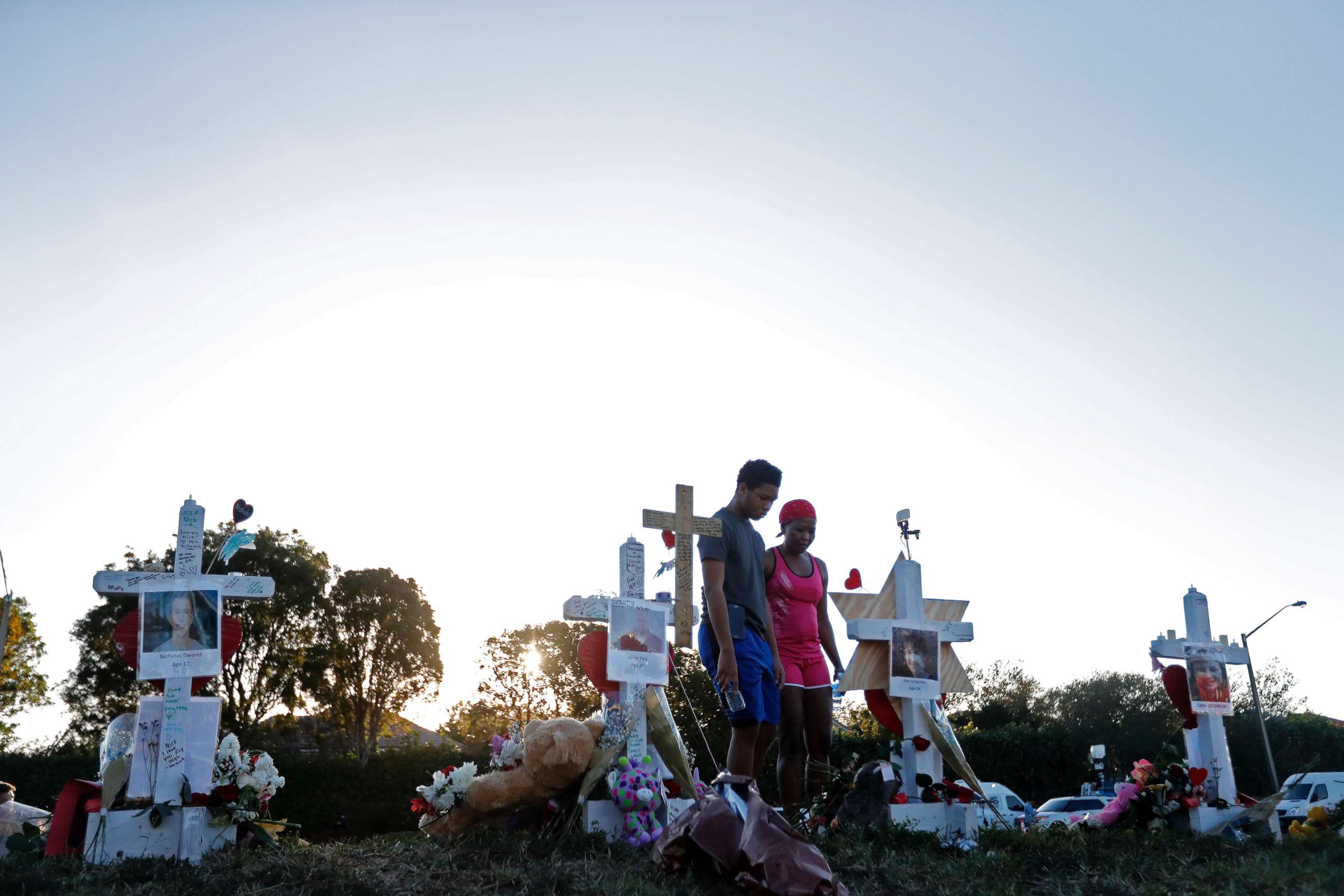 PHOTO: Denyse Christian, visits a makeshift memorial with her son Adin Christian, 16, a student at the school, outside the Marjory Stoneman Douglas High School.