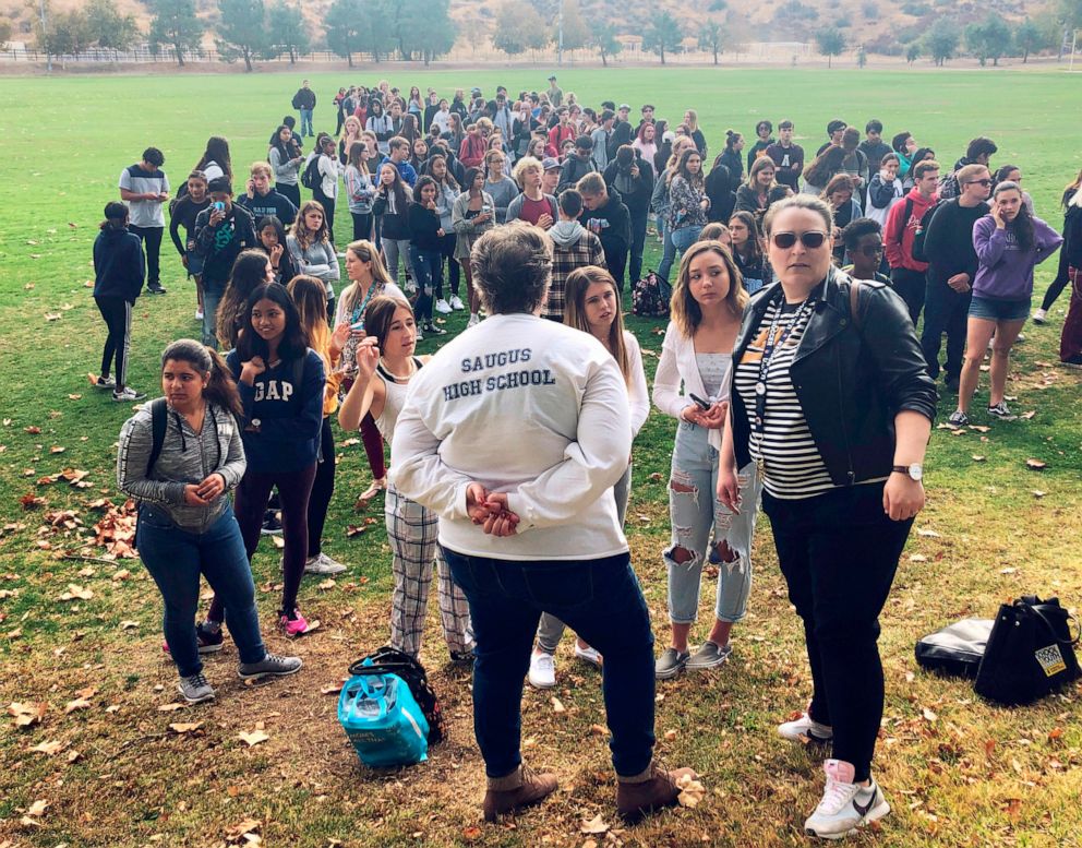 PHOTO: Students and others wait outside a reunification center in Santa Clarita, Calif., after a shooting at Saugus High School, Nov. 14, 2019. 