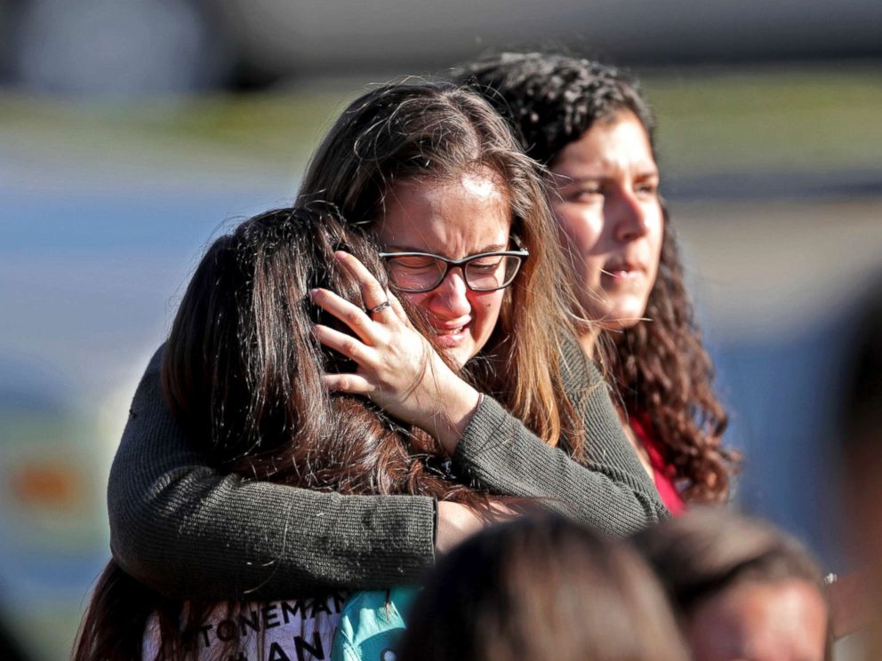 PHOTO: Students released from a lockdown embrace following a shooting at Marjory Stoneman Douglas High School in Parkland, Fla., Feb. 14, 2018.