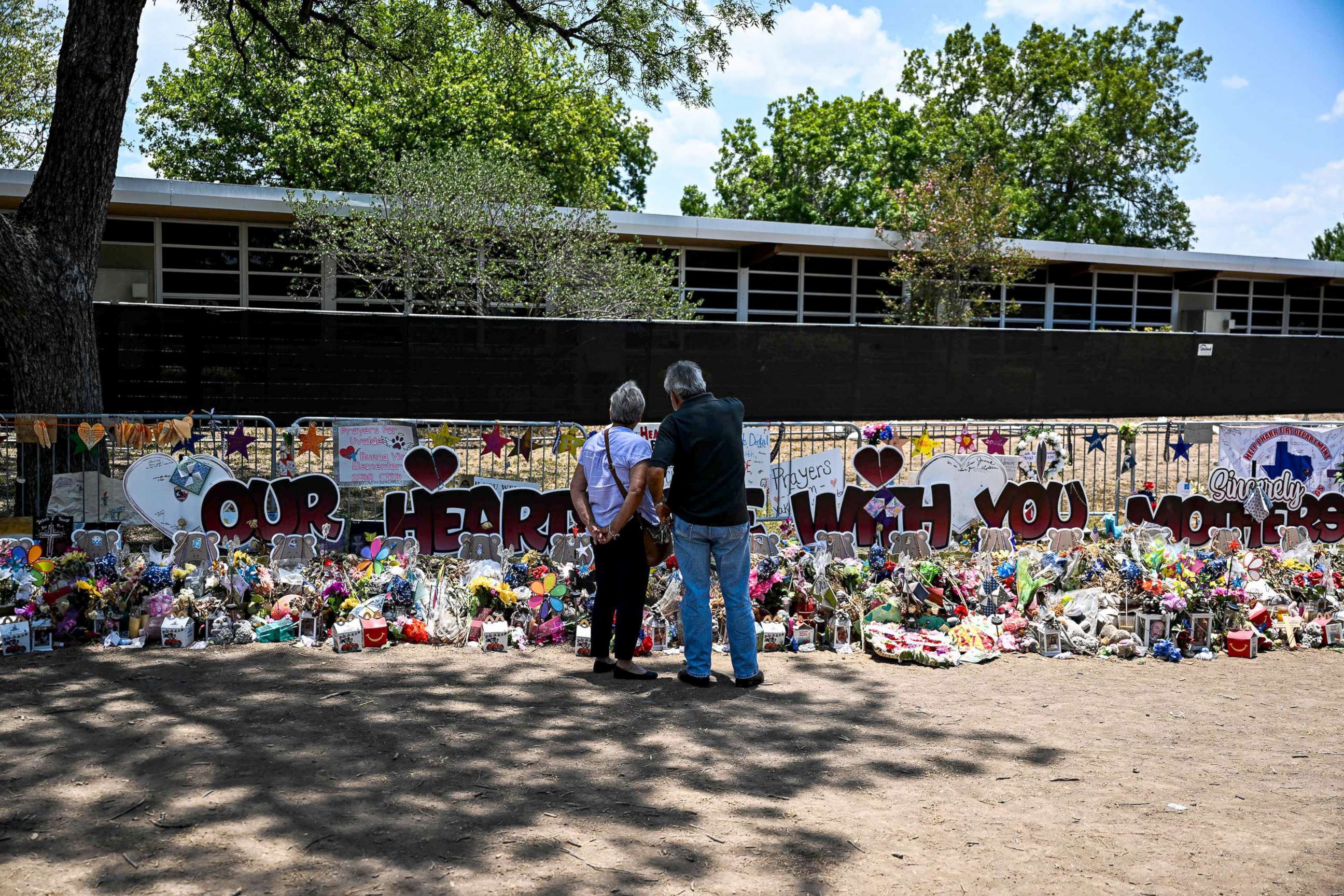 PHOTO: People visit a makeshift memorial to the victims of a shooting at Robb Elementary School in Uvalde, Texas, June 30, 2022.