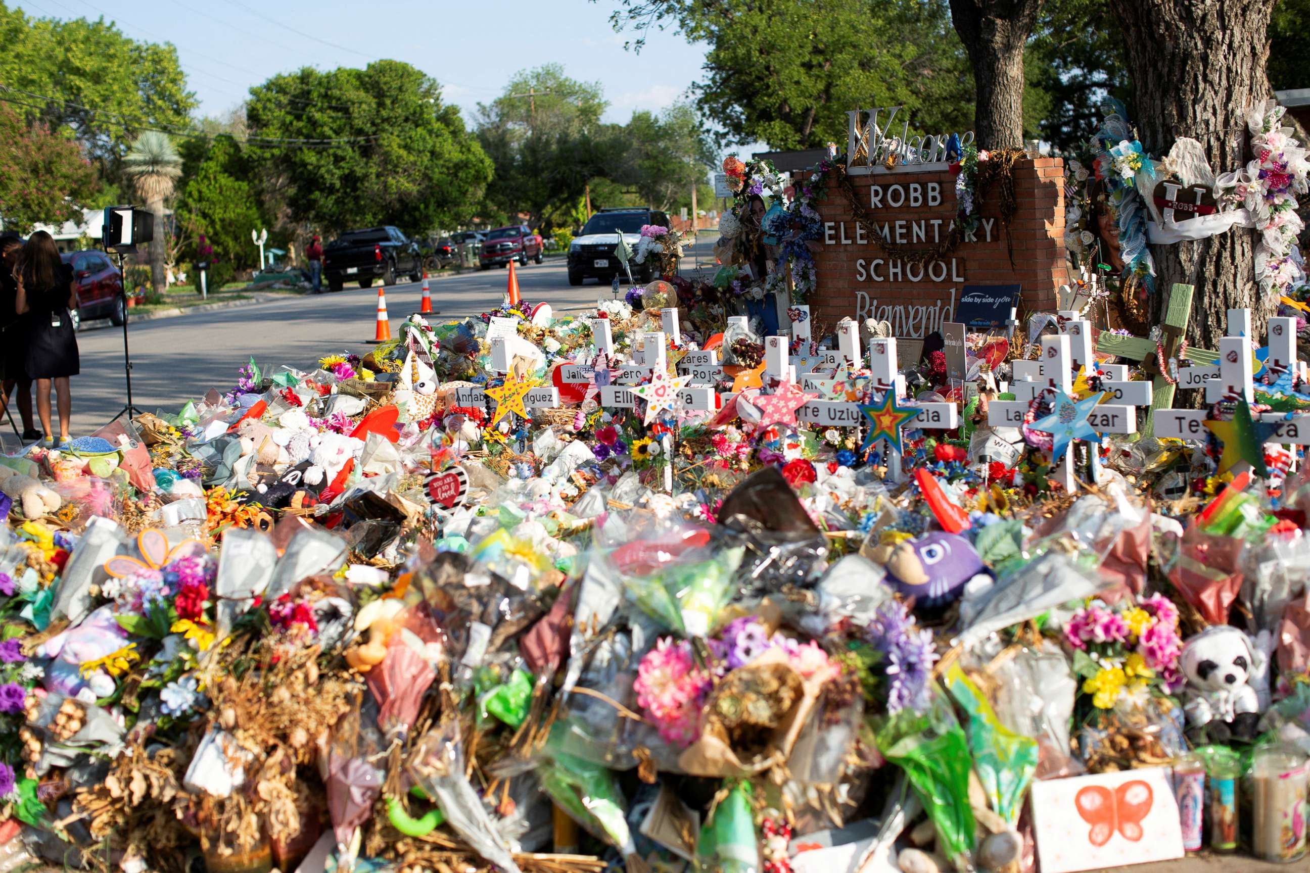 PHOTO:  Weathered signs, candles and stuffed animals remain at a memorial outside Robb Elementary School the day after the video showing the May shooting inside the school released, in Uvalde, Texas, U.S., July 13, 2022. 