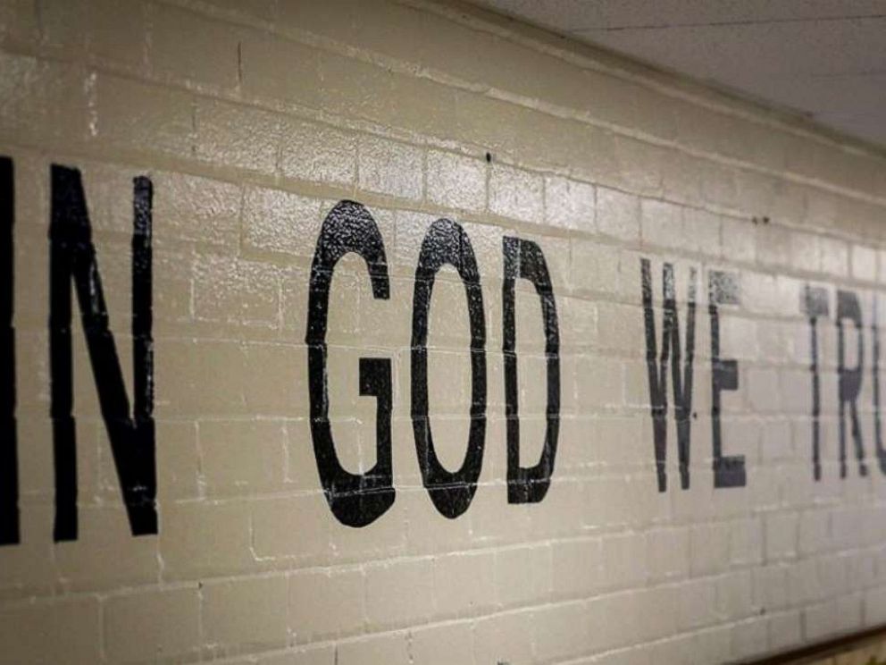 PHOTO: This July 23, 2019 photo shows In God We Trust stenciled in a wall at South Park Elementary in Rapid City, S.D.