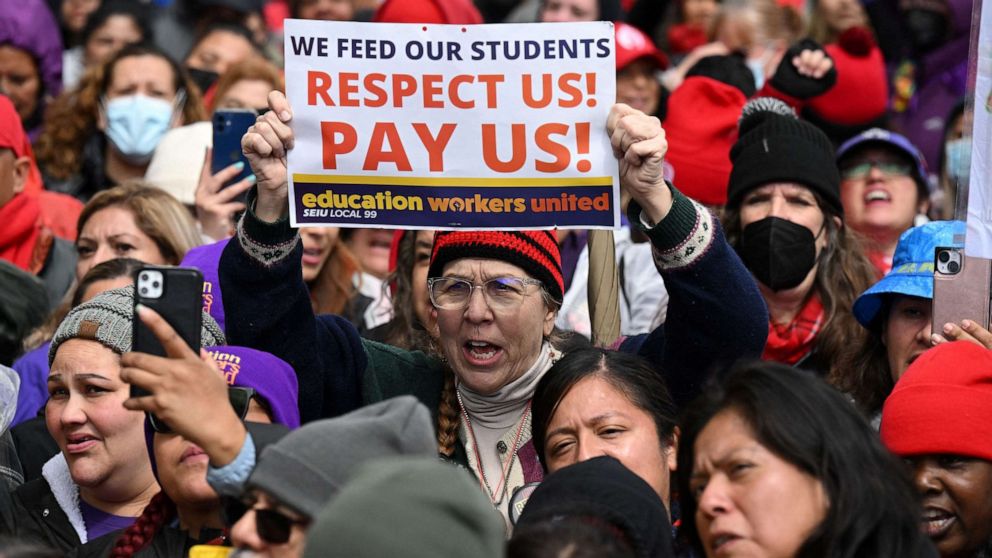 PHOTO: Los Angeles public school support staff and teachers, rally outside of the school district headquarters on the first day of a three day strike, Mar. 21, 2023, in Los Angeles.