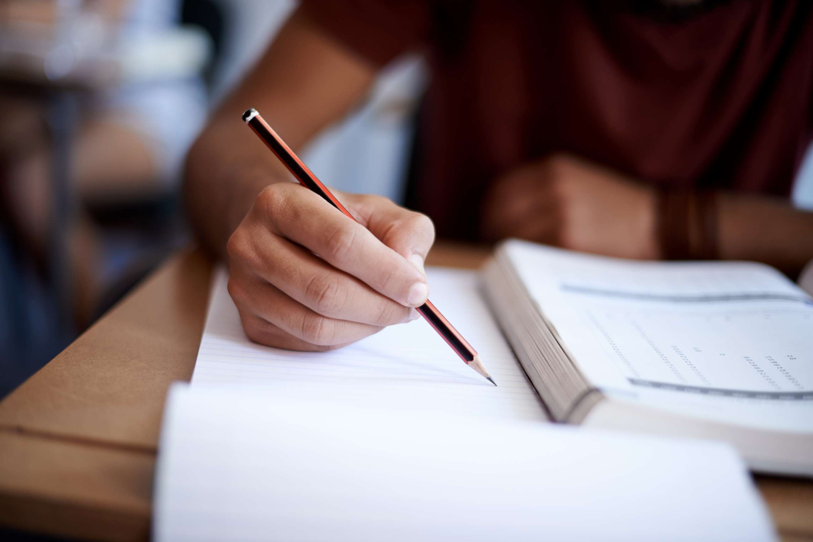 PHOTO: In this undated stock photo is a close-up shot of a young man writing on a note pad.