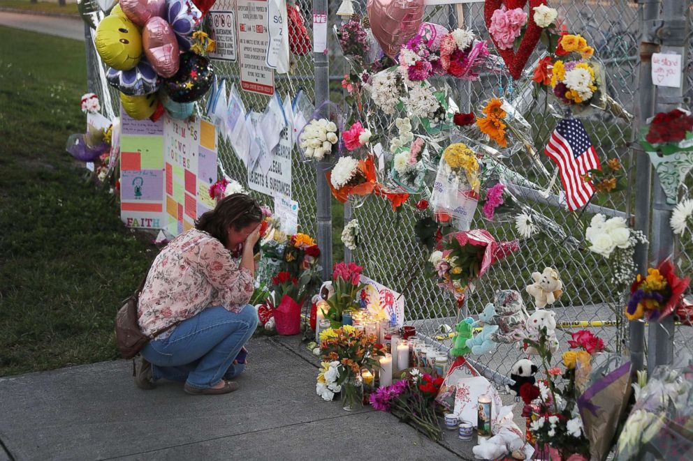 PHOTO: Melissa Goldsmith visits a makeshift memorial setup in front of Marjory Stoneman Douglas High School on Feb. 18, 2018, in Parkland, Fla.