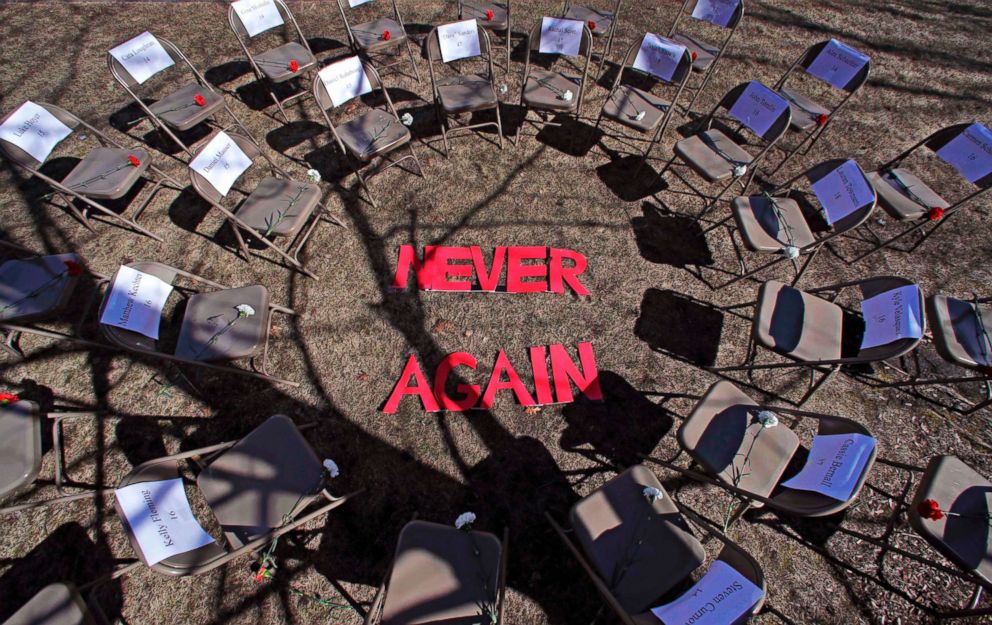 PHOTO: Two rings of chairs encircle the words "NEVER AGAIN" in a silent protest on the 19th anniversary of the Columbine High School shooting outside Trinity High School in Manchester, N.H., April 20, 2018.