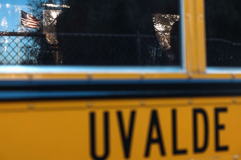 PHOTO: The American Flag is reflected in the window of a Uvalde CISD School Bus on June 24, 2022 in Uvalde, Texas. 