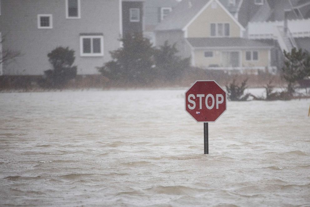 PHOTO: In this March 2, 2018, file photo, a flooded out road with a stop sign is shown as a large coastal storm bears down on the region, in Scituate, Mass.