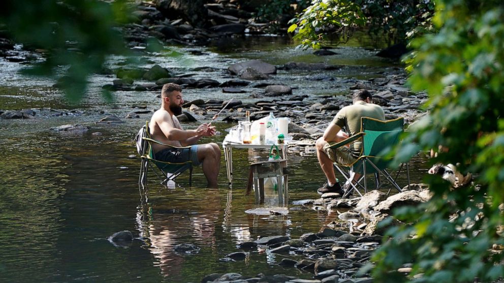 PHOTO: People escape the heat wave by having a barbecue in a river near the village of Luss in Argyll and Bute on the west bank of Loch Lomond, Scotland, July 18, 2022.