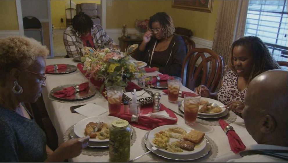 PHOTO: Glenda Barner sits down with her family to have a meal prepared with boiled bottled water.