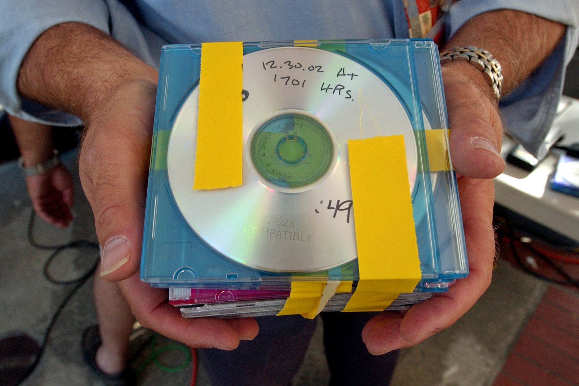 PHOTO:Media pool coordinator Peter Shaplen holds up a released audio copies outside of a Redwood City, Calif., courthouse in this Aug. 16, 2004 file photo of the taped conversations between Scott Peterson and Amber Frey. 