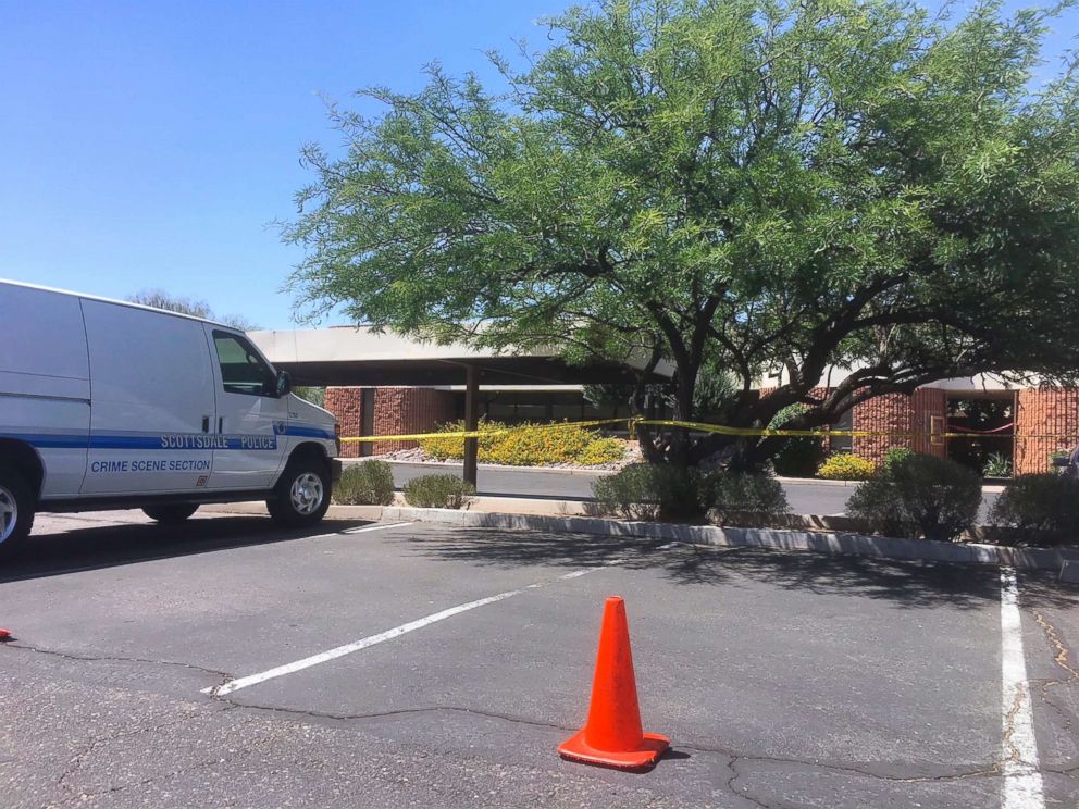 PHOTO: A Scottsdale police vehicle and crime scene tape is seen outside the Scottsdale, Ariz., building where a man was found shot to death on June 2, 2018.