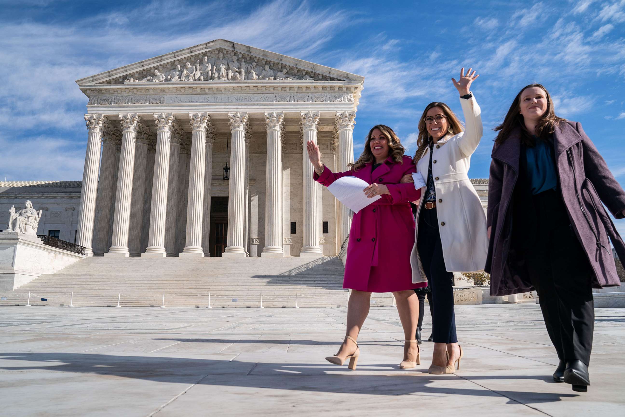 PHOTO: Lorie Smith, a Christian graphic artist and website designer in Colorado, in pink, prepares to speak to supporters outside the Supreme Court on Monday, Dec. 5, 2022 in Washington, DC.