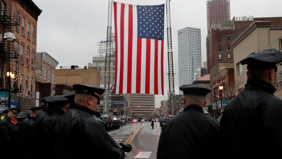 PHOTO: Police officers gather on the street ahead of the funeral service for Jersey City Police Detective Joseph Seals at St. Aedan's Church in Jersey City, N.J., Dec. 17, 2019. 