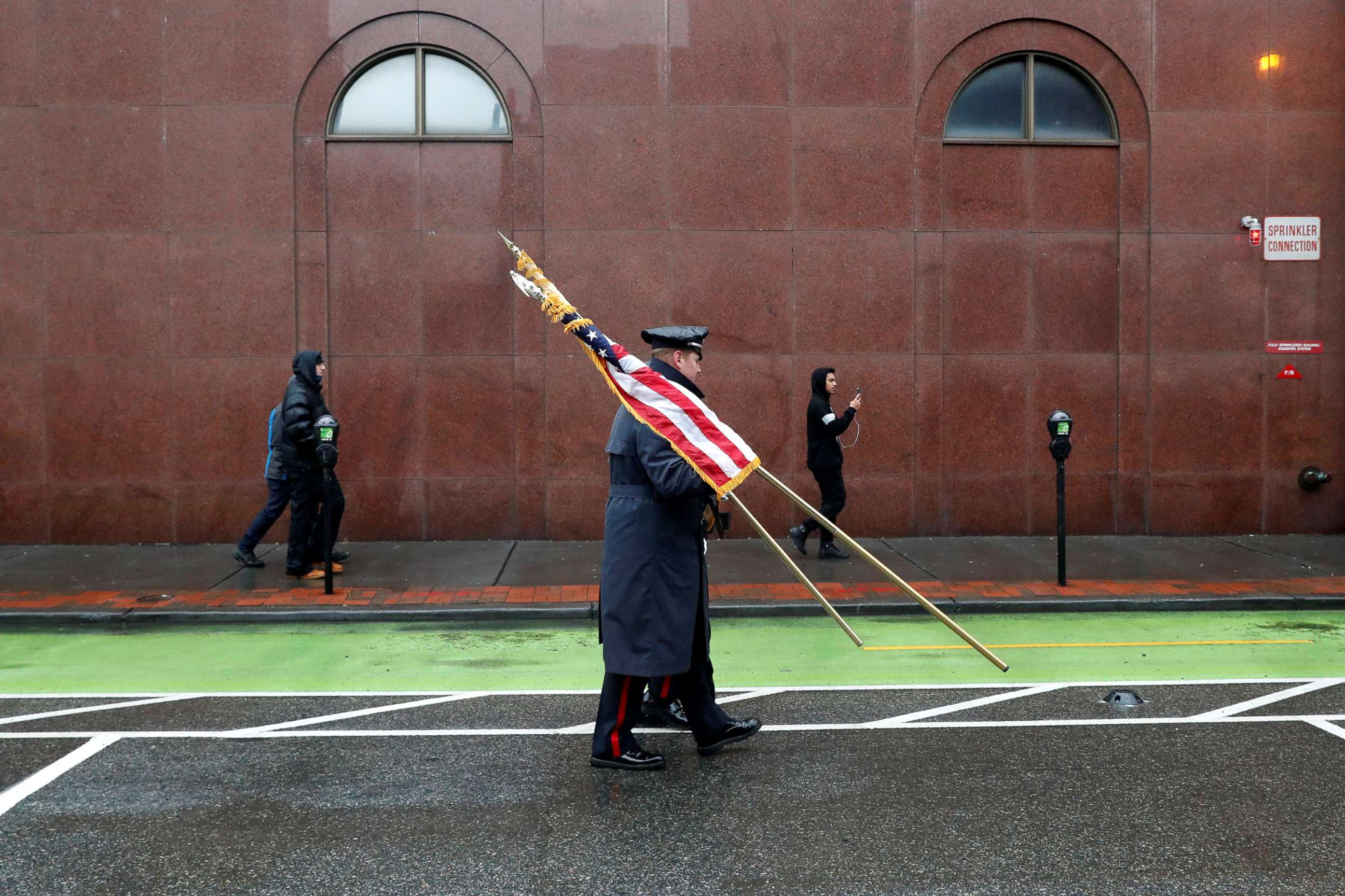 PHOTO: Police officers carry flags ahead of the funeral service for Jersey City Police Detective Joseph Seals at St. Aedan's Church in Jersey City, N.J., Dec. 17, 2019. 