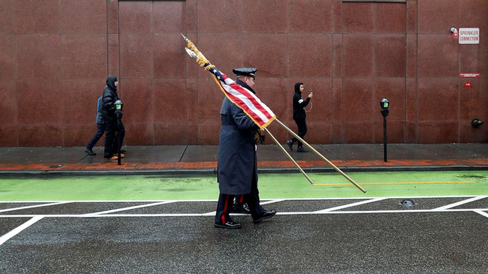 PHOTO: Police officers carry flags ahead of the funeral service for Jersey City Police Detective Joseph Seals at St. Aedan's Church in Jersey City, N.J., Dec. 17, 2019. 