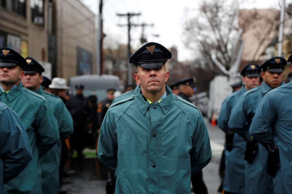 PHOTO: New Jersey State Police officers stand in formation on the street ahead of the funeral service for Jersey City Police Detective Joseph Seals at St. Aedan's Church in Jersey City, N.J., Dec. 17, 2019. 