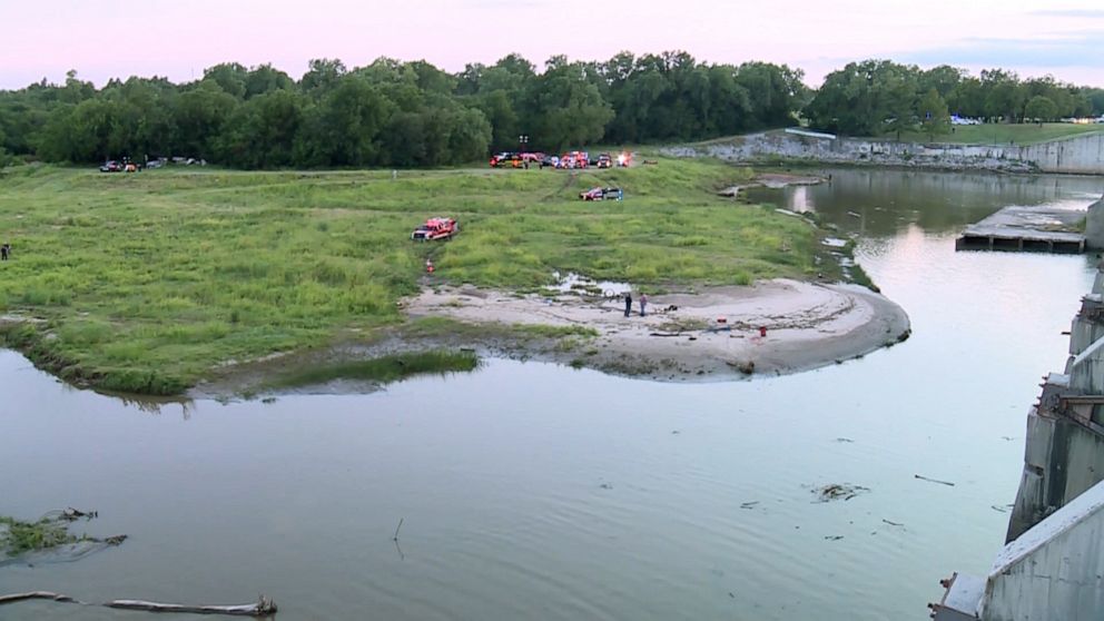 PHOTO: Rescuers search for two boys swept away by strong currents on July 10, 2023, when the dam gates opened at Lake Overholser, in Oklahoma City.