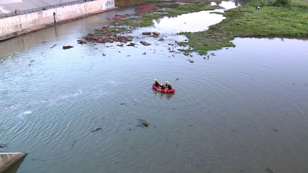 PHOTO: Rescuers search for two boys swept away by strong currents on July 10, 2023, when the dam gates opened at Lake Overholser, in Oklahoma City.