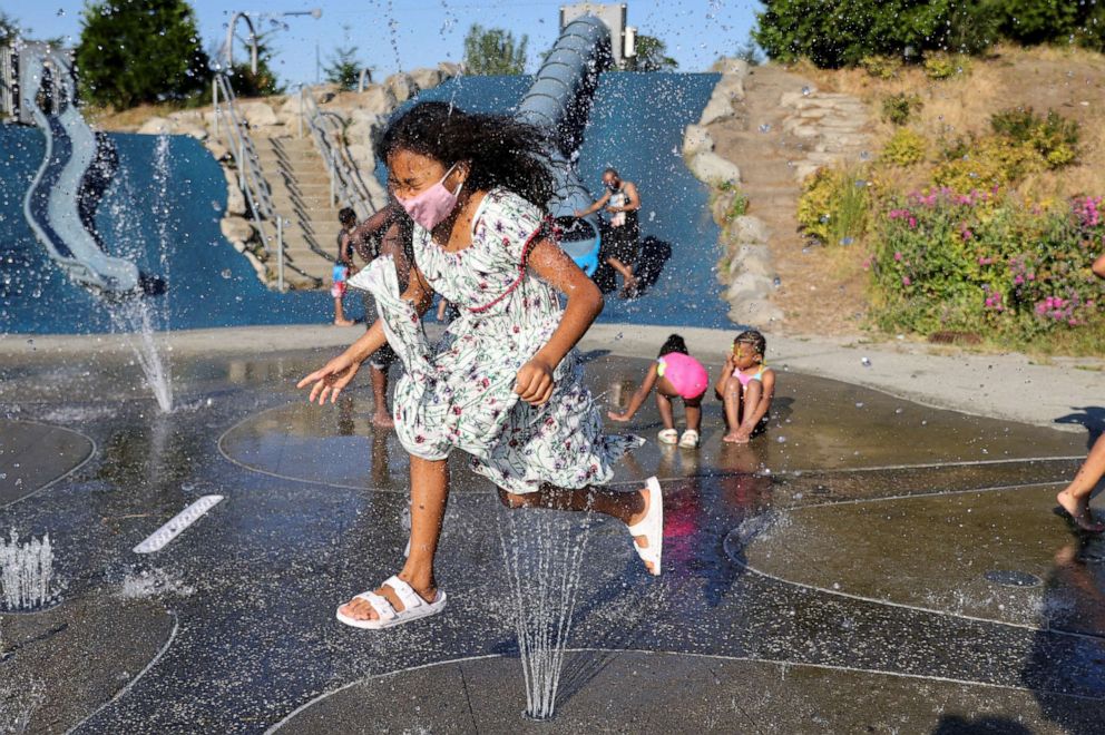 PHOTO: Isis Macadaeg, age 7, plays in a spray park at Jefferson Park during a heat wave in Seattle, June 27, 2021.