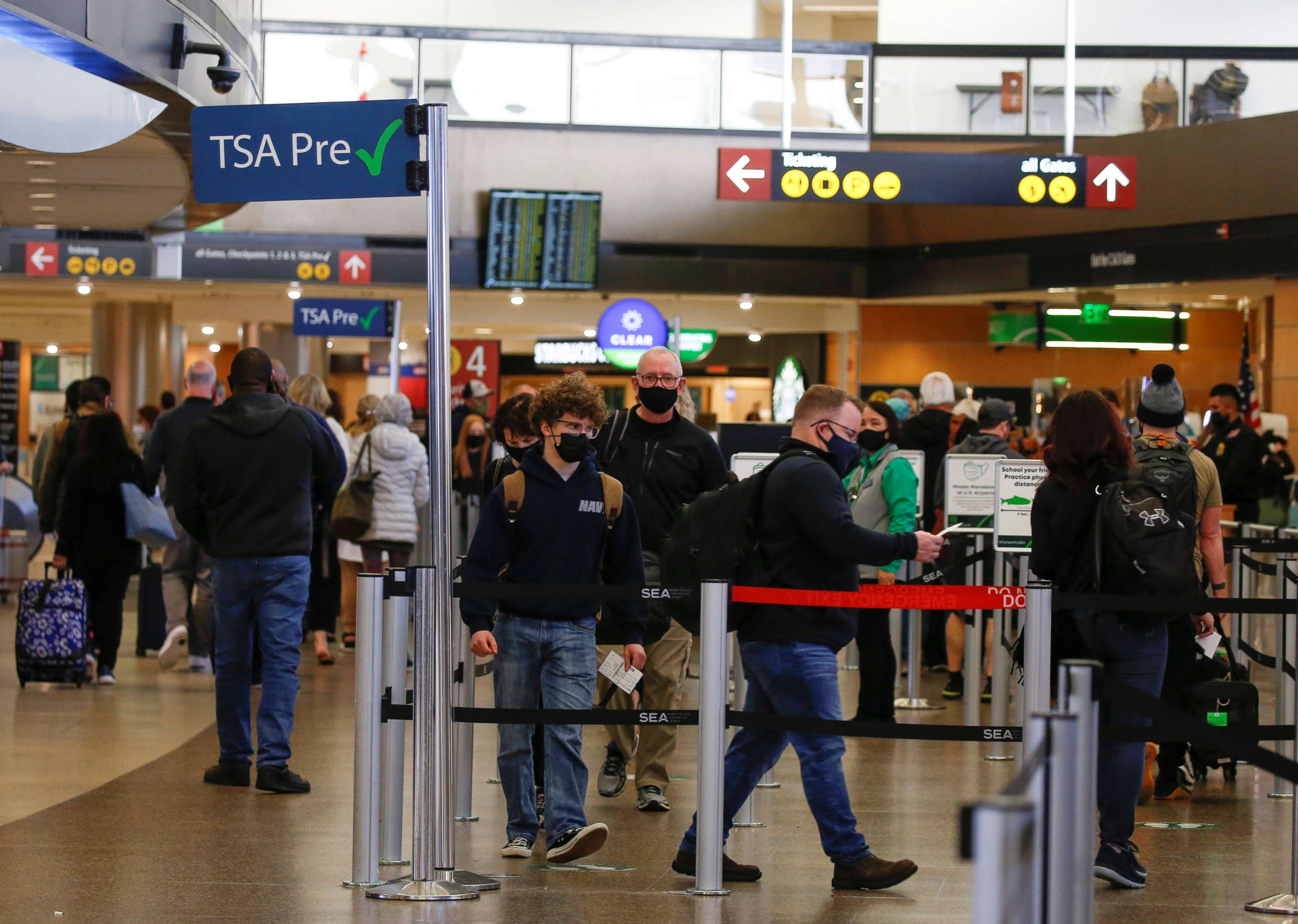 PHOTO: In this April 12, 2021, file photo, people queue in a security checkpoint at Seattle-Tacoma International Airport in SeaTac, Washington.
