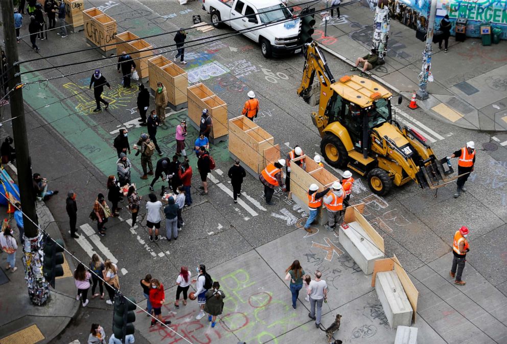 PHOTO: Seattle Department of Transportation crews install concrete barriers as protesters against racial inequality occupy space at the CHOP area near the Seattle Police Department's East Precinct in Seattle, June 16, 2020.