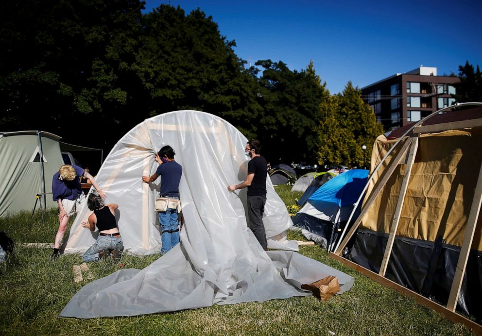 PHOTO: People set up a greenhouse space at a new community garden created by protesters at Cal Anderson Park as they demonstrate against racial inequality and occupy space at the CHOP in Seattle, June 16, 2020.