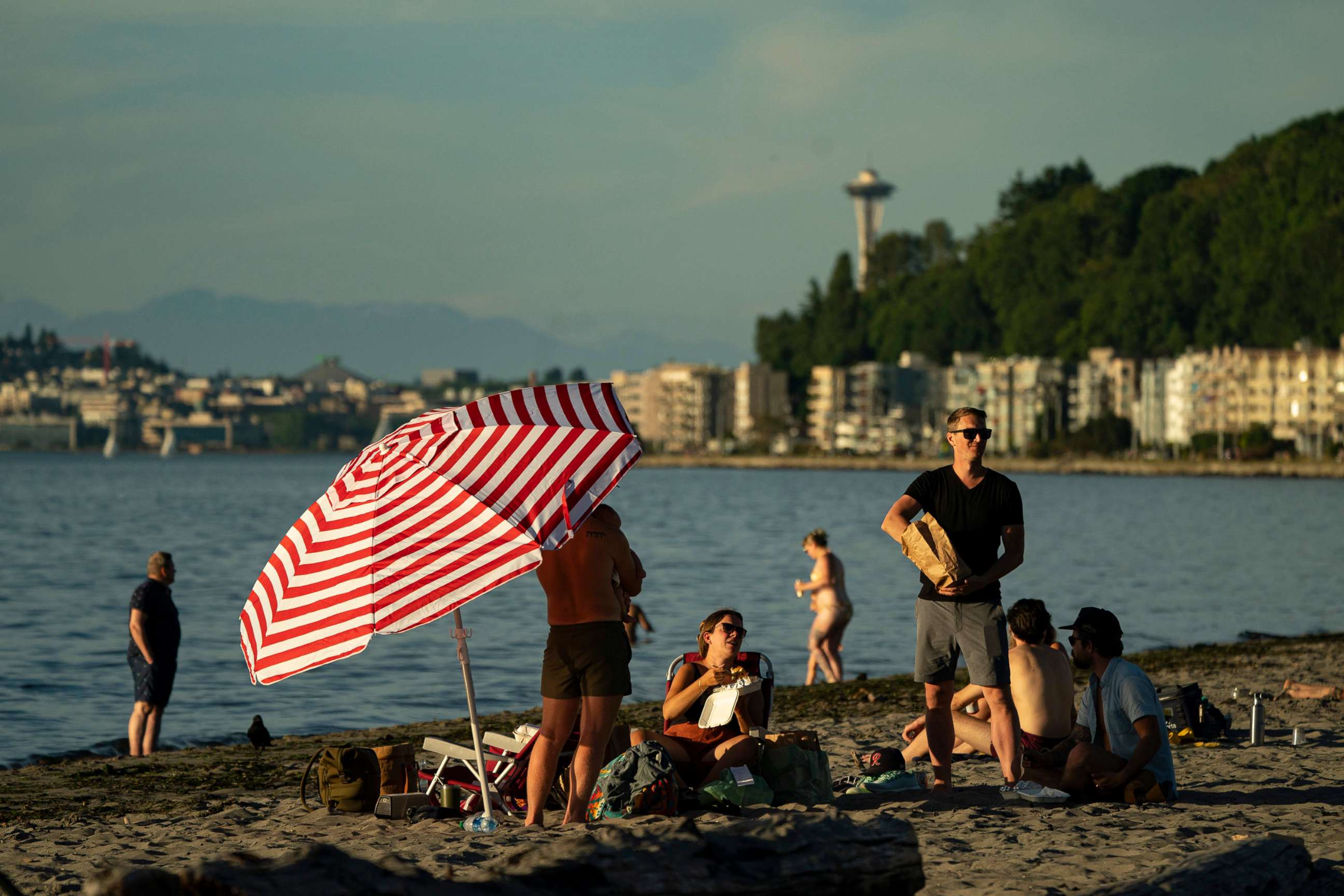 PHOTO: People take in the evening at Alki Beach in Seattle, June 24, 2021. An intense heat wave is set to pummel the Pacific Northwest, potentially setting records in Seattle, Portland and the interior.