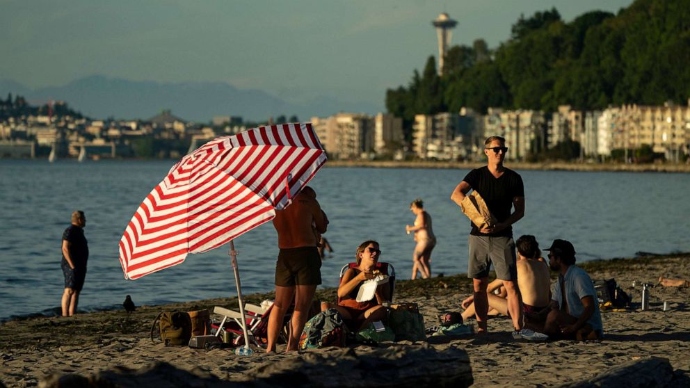 PHOTO: People take in the evening at Alki Beach in Seattle, June 24, 2021. An intense heat wave is set to pummel the Pacific Northwest, potentially setting records in Seattle, Portland and the interior.