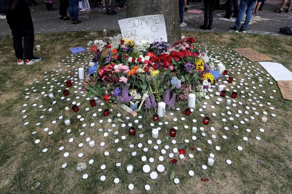 PHOTO: Candles and flowers form a tribute to Summer Taylor and Diaz Love during a rally near the King County Courthouse, July 22, 2020, in Seattle.