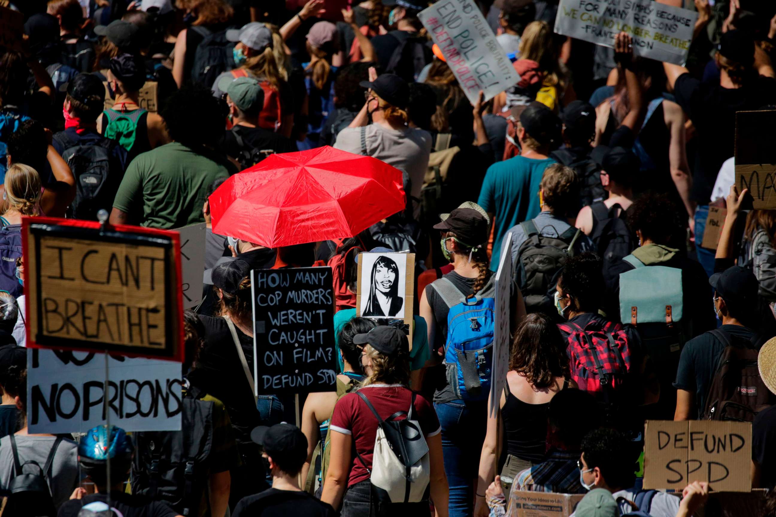 PHOTO: Protesters carry a sign bearing the image of Seattle police shooting victim Charleena Lyles during a "Defund the Police" march in Seattle, Aug. 5, 2020.