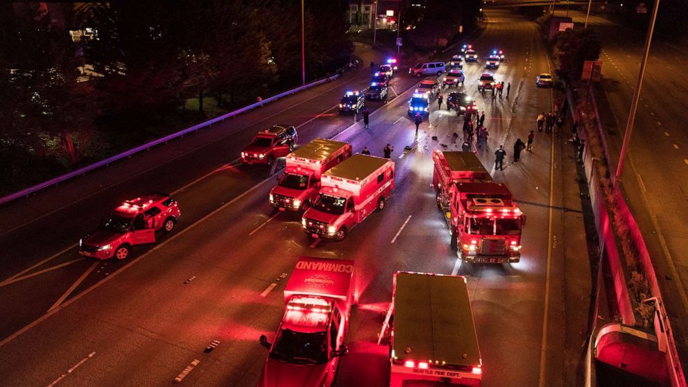 PHOTO: Emergency personnel work at the site where a driver sped through a protest-related closure on the Interstate 5 freeway in Seattle, July 4, 2020. 