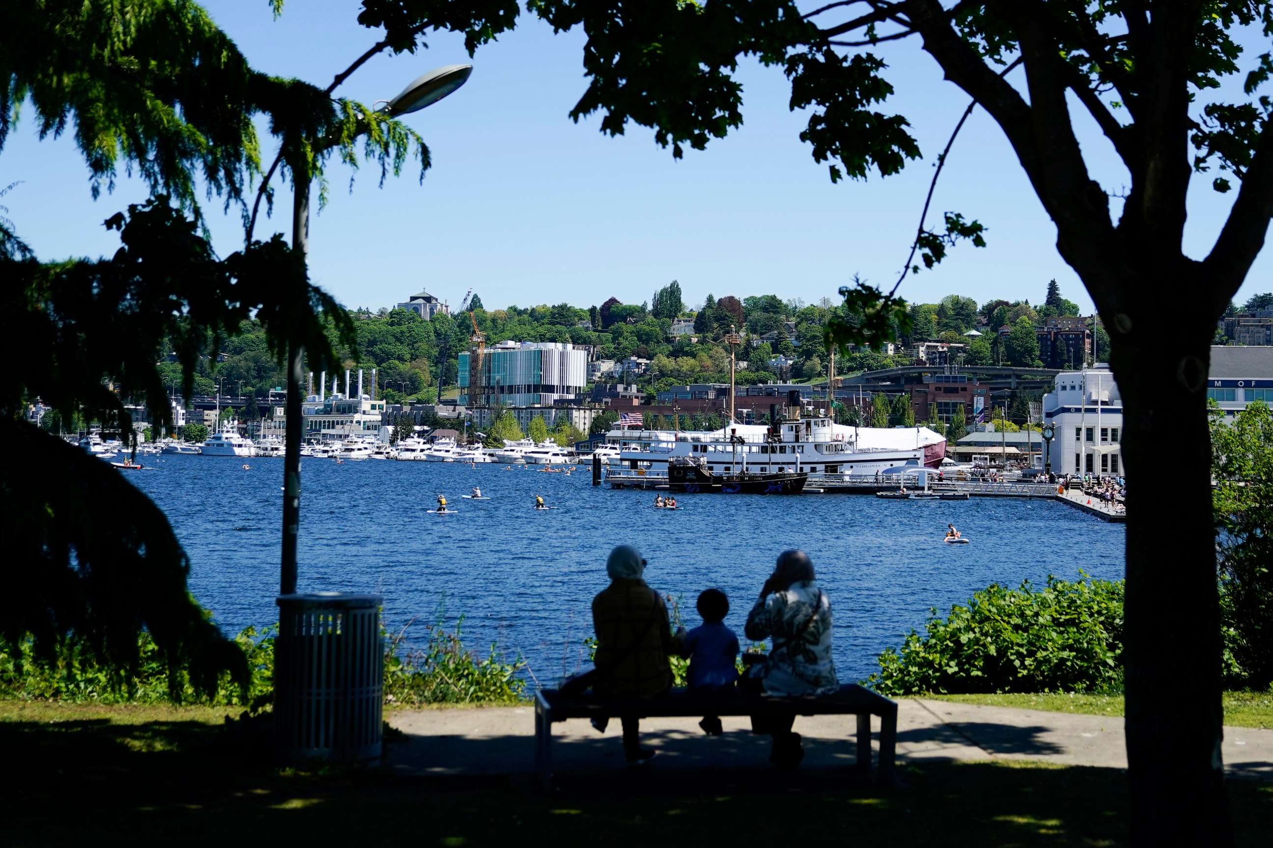 PHOTO: People sit in the shade at Lake Union Park, May 13, 2023, during a heatwave in Seattle.