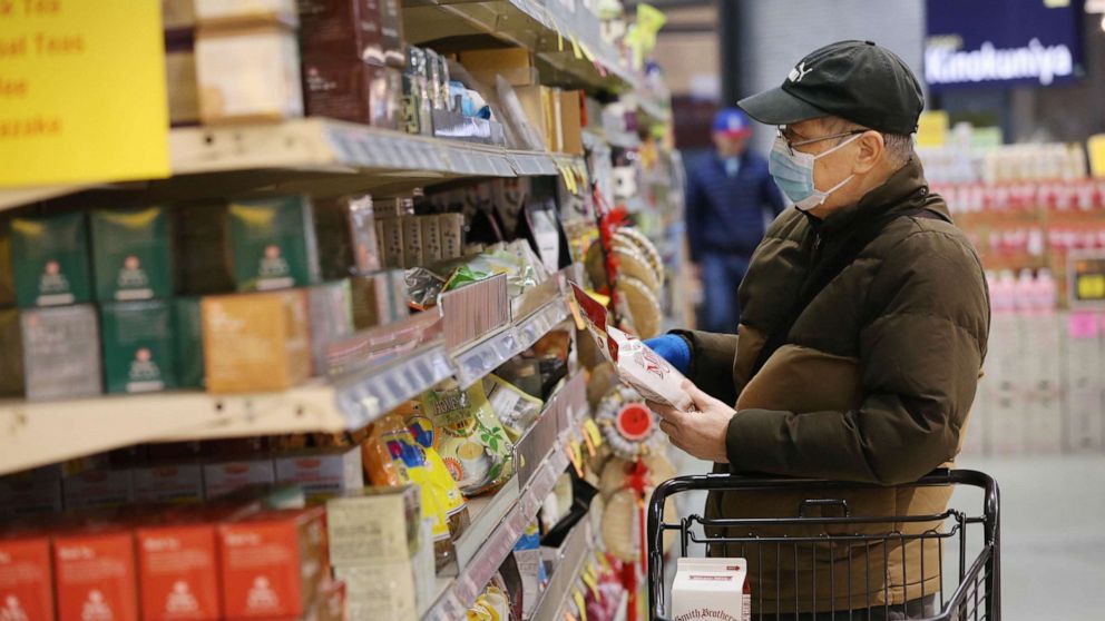 PHOTO: A man shops for groceries during special hours open to seniors only at a supermarket in Seattle, March 18, 2020.