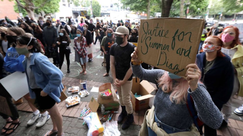 PHOTO: A person holds a sign that reads "Justice for Summer and Diaz," during a rally near the King County Courthouse, July 22, 2020, in Seattle, to call for justice in the death of Summer Taylor, who was killed by a car during a protest.