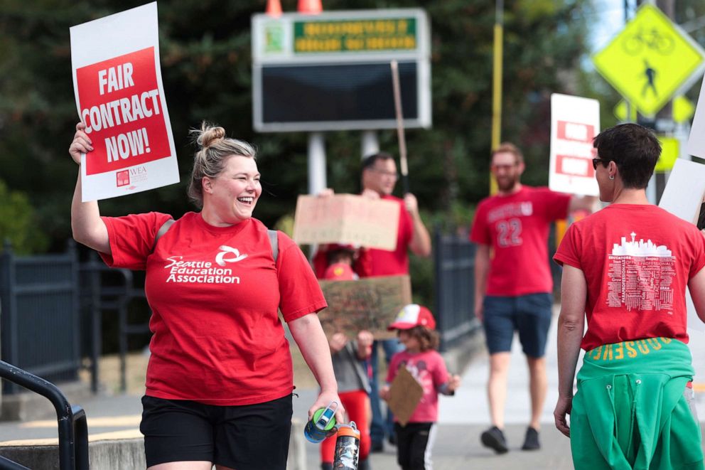 PHOTO: Lucy Magidman, wife of teacher Michael Magidman, shows her support as teachers from Seattle Public Schools picket outside Roosevelt High School on what was supposed to be the first day of classes, on Sept. 7, 2022, in Seattle.